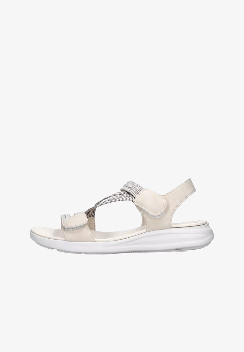 Sandal in beige con una fascia testurizzata, chiusura regolabile in velcro e una suola bianca flessibile. Presenta un profilo basso e un design aperto.