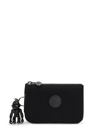 Black fabric cardholder with a textured logo patch, zip closure, and a glossy black monkey figurine charm attached.