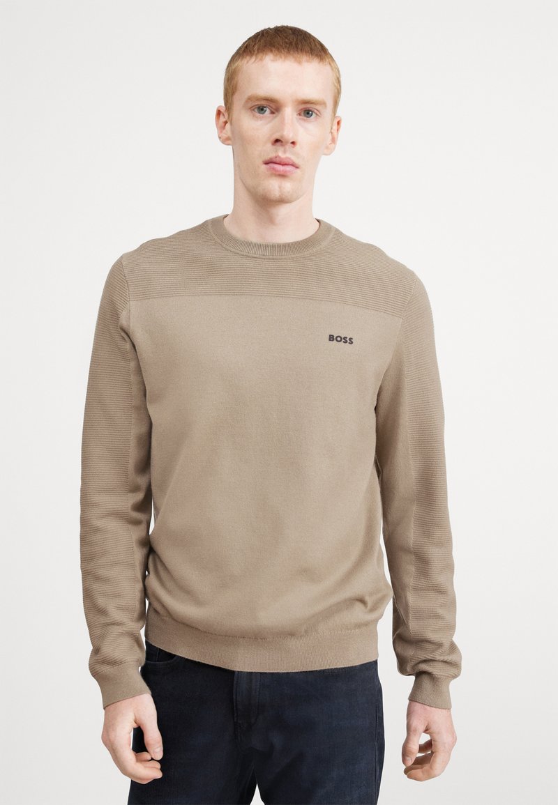 Beige knit sweater with a textured upper panel, ribbed cuffs, and hem. Features a small black "BOSS" logo on the chest.