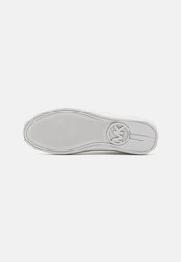 Weiße Sneaker-Sohle aus strukturiertem Gummi, kreisförmiges Logo an der Ferse und glattes Design. Die geschwungene Form und klaren Linien verbessern die Funktionalität.