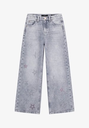 Weite Jeans in verwaschenem hellblauen Denim mit sternförmigen Verzierungen in Silber und Lila. Klassisches Fünf-Taschen-Design.
