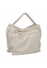 Sac à main en tissu beige doux avec une anse tressée, un dessus froncé et une poche zippée à l'extérieur. Texture lisse et design spacieux.