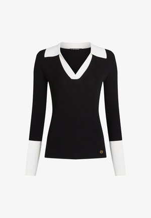 Top de manga larga negro con canalé, con un cuello en V blanco y acentos en blanco en los puños; presenta un pequeño detalle de logotipo dorado cerca del dobladillo.