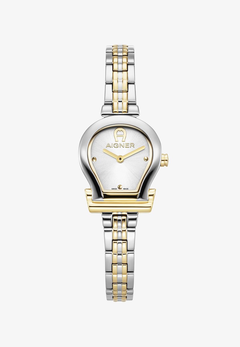 Sudraba un zelta metāla pulkstenis ar apaļu korpusu un baltu ciparnīcu. Ietver zelta stundas un minūtes rādītājus, zīmolu logo un divkrāsu rokas siksnu.