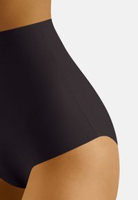 Shapewear nero a vita alta con una texture liscia e un design senza cuciture, caratterizzato da una linea pulita in vita e una curva sottile.