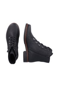 Bottines en cuir noir avec lacets, fermeture éclair sur le côté et un accent de couture marron sur la semelle. Présentent une pointe arrondie et un dessus texturé.