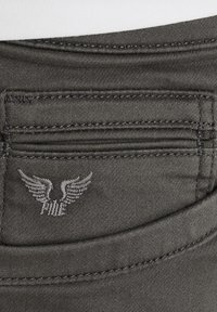 Dark gray denim pants featuring a small embroidered logo with wings on the back pocket; visible stitching and pocket design detail.