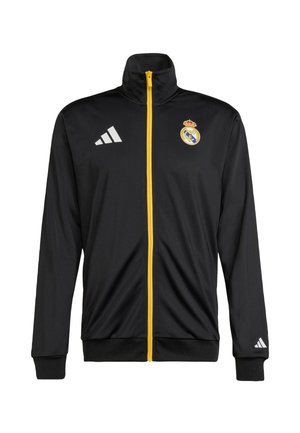 Black athletic jacket with a high collar, yellow front zipper. Features the Real Madrid logo and three white Adidas stripes on the left sleeve.