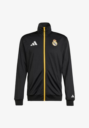 Black athletic jacket with a high collar, yellow front zipper. Features the Real Madrid logo and three white Adidas stripes on the left sleeve.