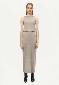 Grått ribbat tvådelat klänning som har en ärmlös crop top och en lång, figurnära kjol. Slät textur med en minimalistisk design.