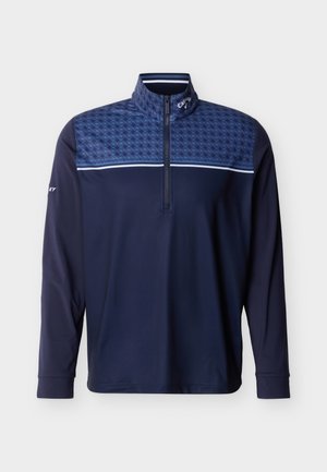 Μακρυμάνικο πουλόβερ σε ναυτικό μπλε χρώμα με φερμουάρ στο ένα τέταρτο, μοτίβο στο πάνω μέρος του στήθους και στους ώμους, και ψηλό γιακά.