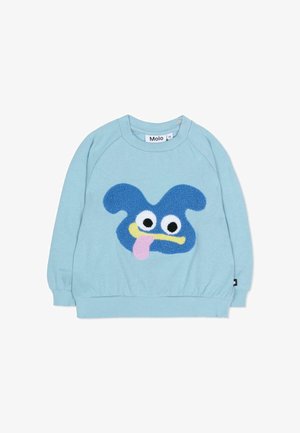 Felpa azzurro chiaro con una faccia a fumetti blu testurizzata, grandi occhi bianchi, lingua gialla e accento rosa. Polsini e orlo a coste.