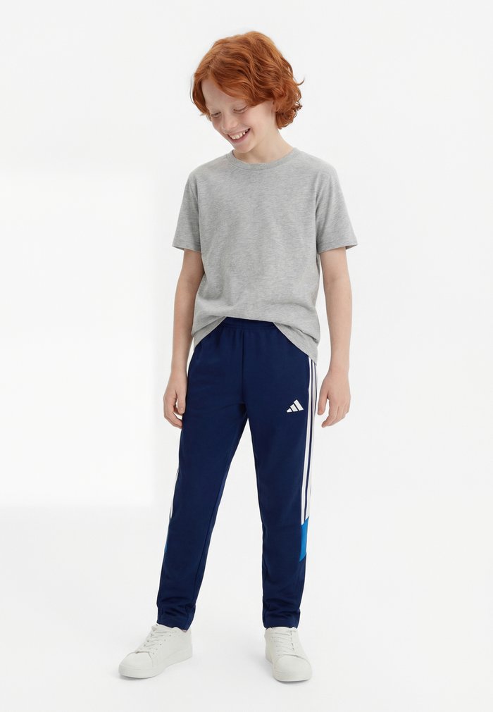 adidas TIRO ESSENTIALS PANTS KIDS UNISEX - Tracksuit bottoms - dark blue/bright royal/white