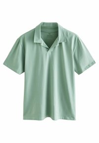 Polo in cotone verde chiaro con colletto classico, maniche corte e patta con tre bottoni, caratterizzato da una vestibilità rilassata.