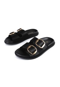 Black slide sandals with two wide straps featuring large gold buckles. Made of smooth material with a cushioned sole for comfort.
