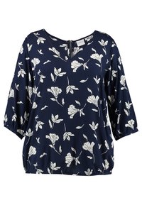 Laivastonsininen paita, jossa on valkoinen kukkakuosi, V-pääntie ja kolme neljänneksen hihat. Kevyt kangas, jossa on gathered helma vyötäröllä.