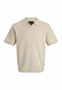 Polo à manches courtes beige clair en tissu texturé, avec un col classique et une ouverture en V, doté d'un ourlet droit.