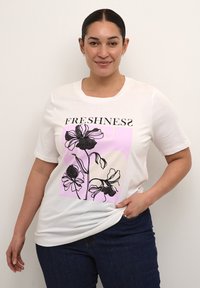 White cotton t-shirt featuring a black floral graphic with pink accents; text "FRESHNESS" displayed above the design. Short sleeves, relaxed fit.