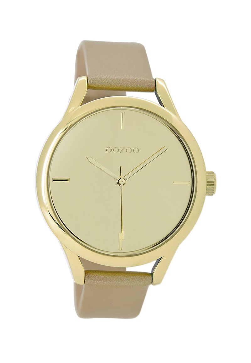 Montre analogique dorée au design minimaliste, avec un cadran rond, un bracelet beige et de simples index horaires. Elle dispose d'une petite couronne.