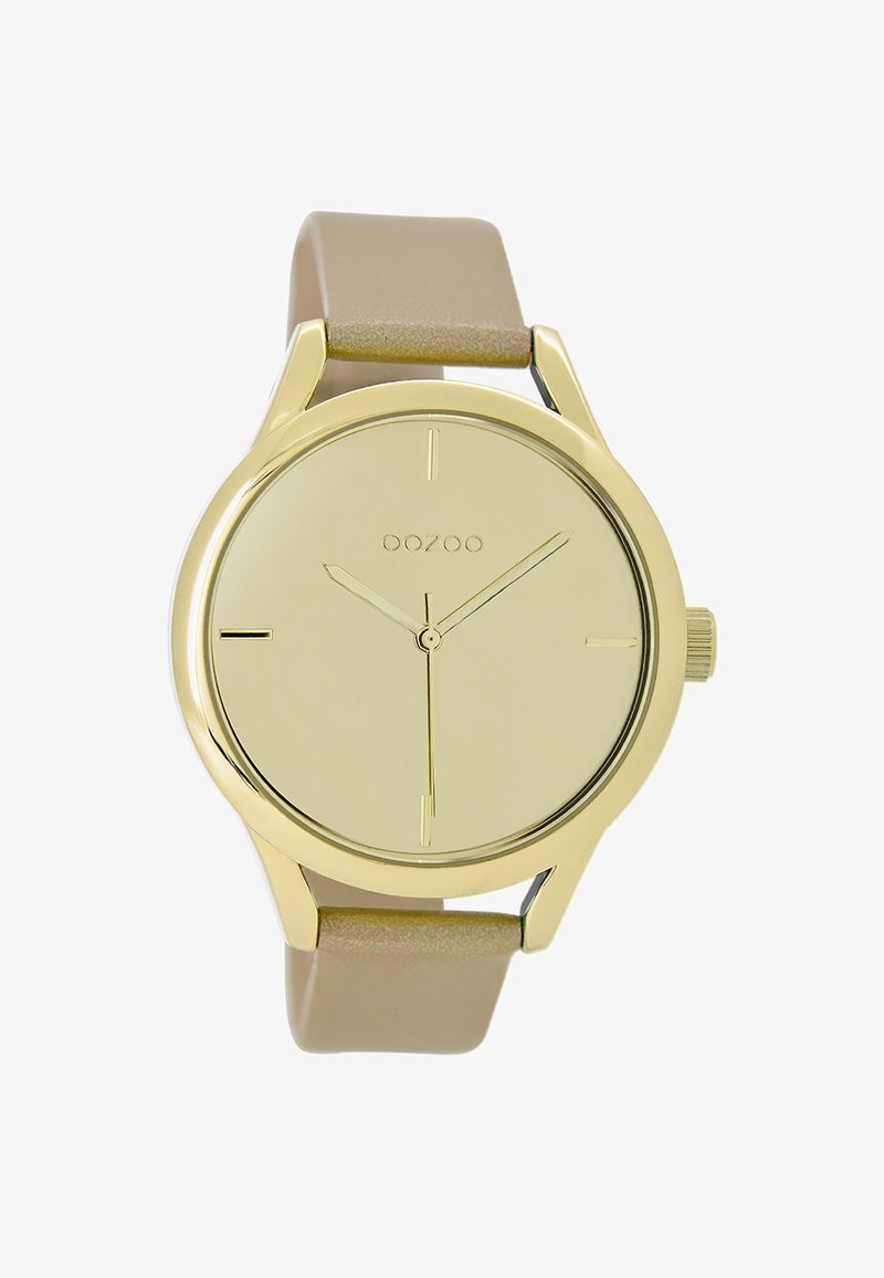 Montre analogique dorée au design minimaliste, avec un cadran rond, un bracelet beige et de simples index horaires. Elle dispose d'une petite couronne.