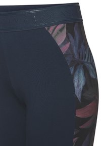 Navy blue leggings with a wide waistband, featuring a floral pattern in purple and green on the side panels. Made from stretchy fabric.