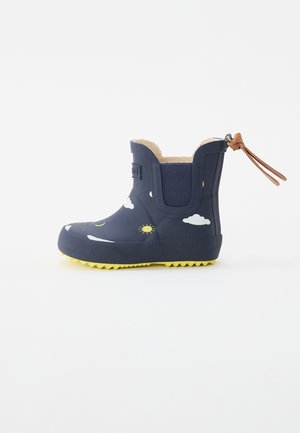 Child's navy blue rain boot with yellow sun and white cloud patterns, textured sole, elastic side panels, and brown pull tab loop.
