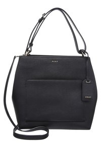 Czarna torebka DKNY o teksturowanej powierzchni, geometrycznym kształcie, z górnym uchwytem i przednią kieszenią. Posiada małą metkę z nazwą marki.