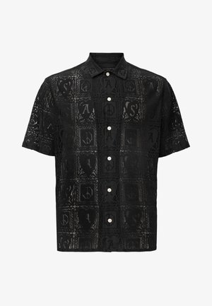 Camicia nera a maniche corte con un design in pizzo caratterizzato da motivi quadrati, loghi discreti e chiusura con bottoni. Leggera, con una trama trasparente.