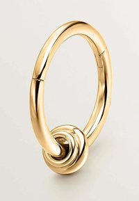 Agujero de puerta circular de tono dorado con un diseño retorcido y una textura suave, que presenta una base redondeada que añade estabilidad y agarre.