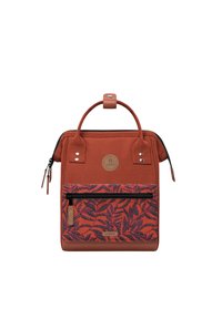 Rust-colored backpack with a leaf-patterned front pocket, textured fabric, dual handles, and a zip closure. Features a logo accent.