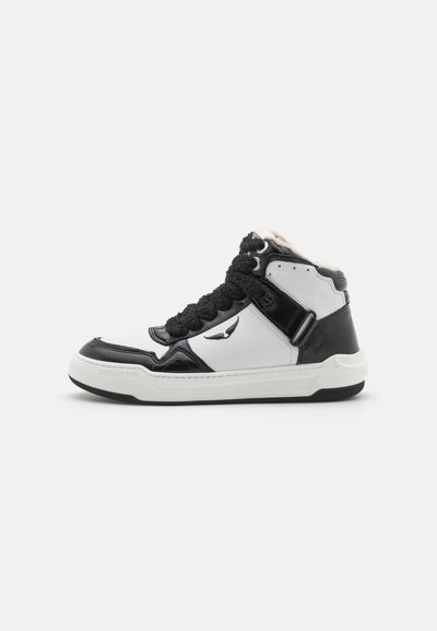 High-top sneaker with black and white leather, textured black accents, padded collar, and braided laces, featuring subtle star details.