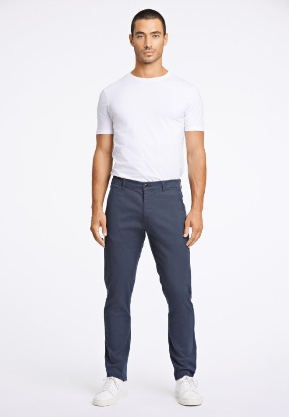 Navy blue pants with a slim fit, cotton fabric, zip fly with button closure, side pockets, worn with a short-sleeve white t-shirt and white sneakers.