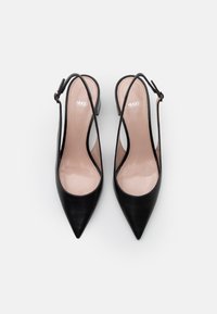 Black slingback high heels with a pointed toe and smooth leather finish. Features a nude insole and an adjustable ankle strap. Logo embossed.
