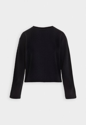 Black cable knit sweater with long sleeves, ribbed cuffs, and a crew neckline. Features a textured pattern throughout, cropped length.