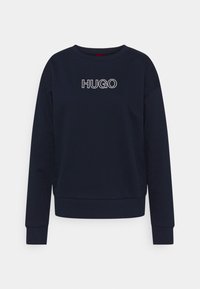 Mörkblå sweatshirt med rund hals, långa ärmar, ribbade muddar och fåll. Har vit "HUGO"-logotyp på framsidan. Mjuk och slät yta.