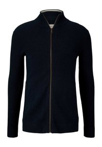 Pull en maille bleu foncé avec col haut, zip sur toute la longueur, texture côtelée et doublure intérieure contrastante, avec des poignets et un ourlet ajustés.