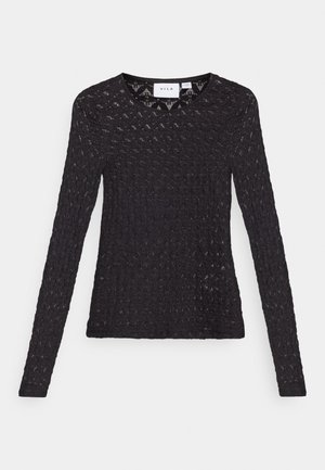 Fekete, hosszú ujjú felső texturált kötött anyagból, amelyen félkörös minta található, és kerek nyakkivágású.