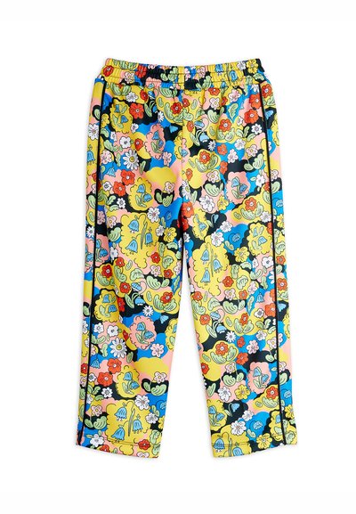 Pantalones coloridos con cintura elástica que presentan un patrón floral y abstracto en rosa, azul, amarillo y negro, con franjas laterales en contraste.