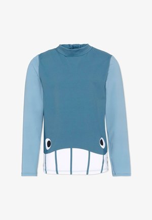 Maillot de bain à manches longues pour enfants avec un motif de visage de baleine bleue, incluant les yeux et les dents sur le panneau avant.