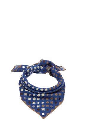 Niebieska chusta z brązowymi i beżowymi geometrycznymi wzorami, związana na supeł z falistymi krawędziami i okrągłymi wycięciami wzdłuż brzegu.