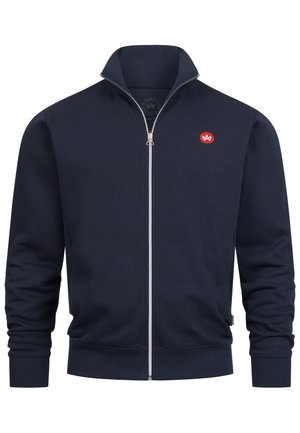 Marineblauer Zip-Hoodie aus weichem Stoff, mit hohem Kragen, gerippten Bündchen und einem kleinen roten Logo auf der linken Brust.