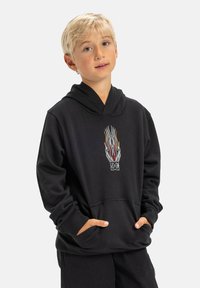 Čierna mikina s kapucňou a predným vreckom, s farebnou grafiku plameňa na hrudníku. Mäkkučký materiál, štandardný strih, dlhé rukávy a kapucňa.