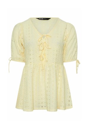 Blouse jaune à manches courtes en broderie anglaise avec col en V, détails noués à l'avant, taille froncée et manches bouffantes avec liens sur les côtés.