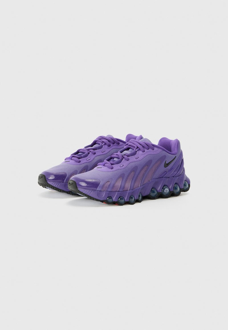 Lila Sportschuhe mit einer glatten Oberseite, Netzdetails, schlankem Profil und einer schwarzen strukturierten Sohle mit dämpfenden Akzenten.