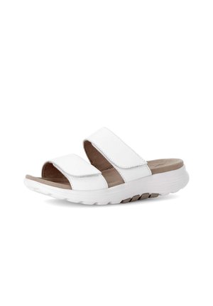 Witte open teen sandaal met twee verstelbare banden en gevoerde zool, schuin geplaatst om de zijkant en bovenkant te tonen.