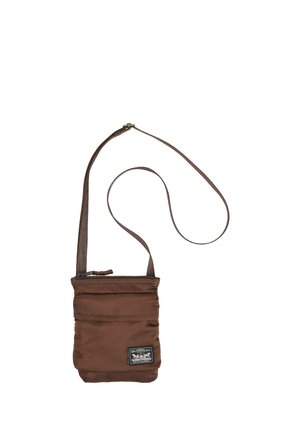 Brun stof crossbody-taske med justerbar rem og Levi Strauss & Co. logo-badge på frontens nederste højre hjørne.