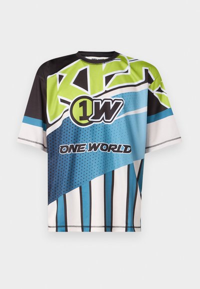 Multicolored sports-inspired t-shirt featuring blue, green, black, and white geometric patterns and large graphic text details.