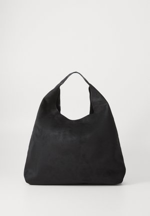 Pehmea musta seemisnaha õlgakott laia kaarekujulise käepidemega ja pehme, avara kehaga valgel taustal.