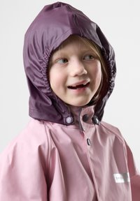 Waterproof pink rain jacket with a purple hood, featuring snap buttons and an elasticized collar, showcased on a light background.