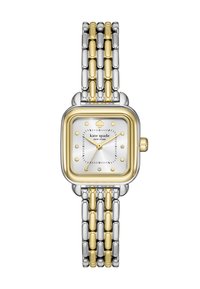 Fyrkantig klocka med ett band av silver och guld. Har en vit urtavla, guldaccenter och juvelprickar som timmarkörer. Anmärkningsvärd spade-logotypdesign.